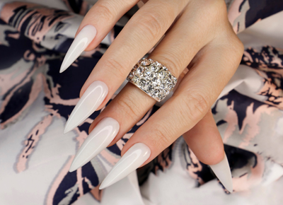 Long light manicure with jewelry womans hand